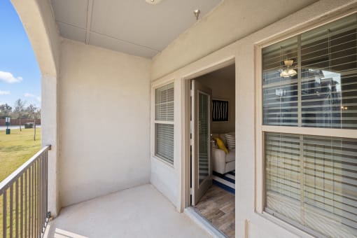 a patio with a door and a couch in the background