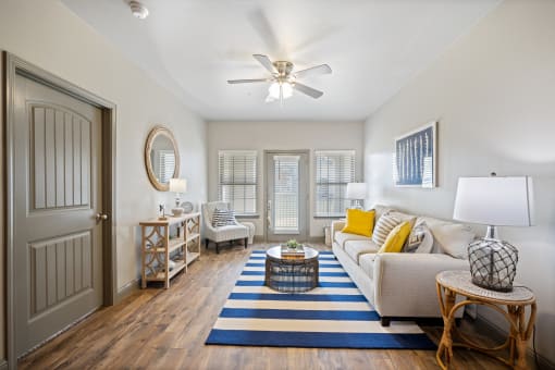 a living room with a ceiling fan and hardwood flooring