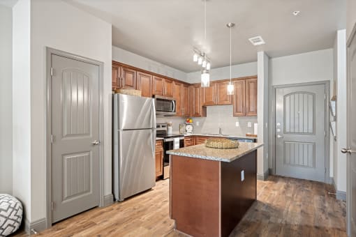 a kitchen with wooden cabinets and stainless steel appliances