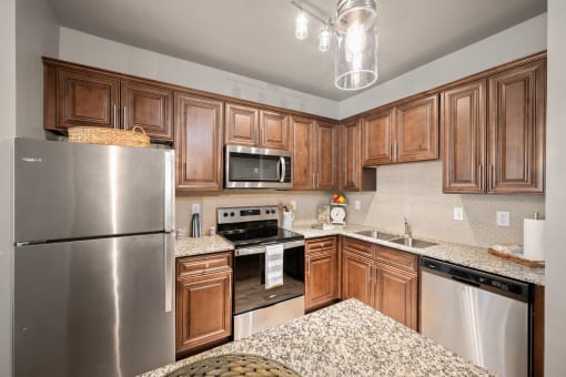 a kitchen with wooden cabinets and granite countertops