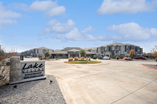 a sign that reads lake villas in front of a row of houses