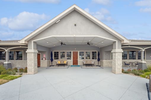 a large patio with chairs and umbrellas in front of a building