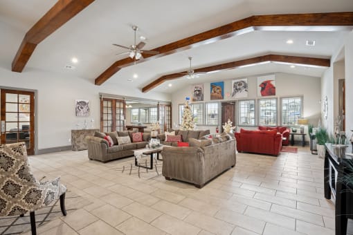 a living room filled with furniture and a ceiling with beams