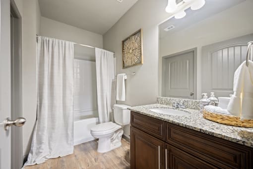 a bathroom with a toilet sink and shower