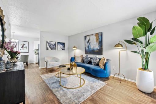 a living room with a blue couch and a table