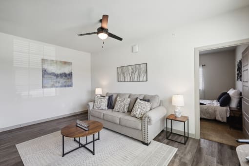 a living room with a couch and a ceiling fan