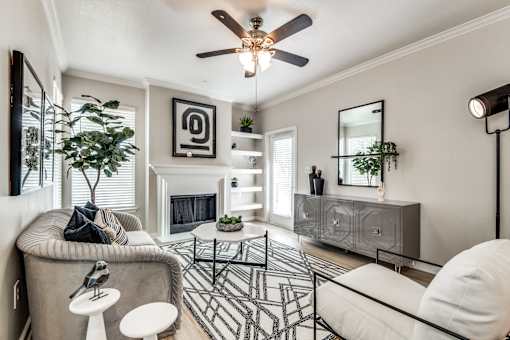 A living room with a fireplace, a chair, a sofa, and a coffee table.