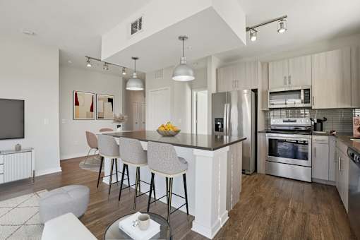 A modern kitchen with large granite island counter.