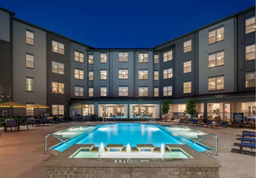 a large swimming pool in front of a building