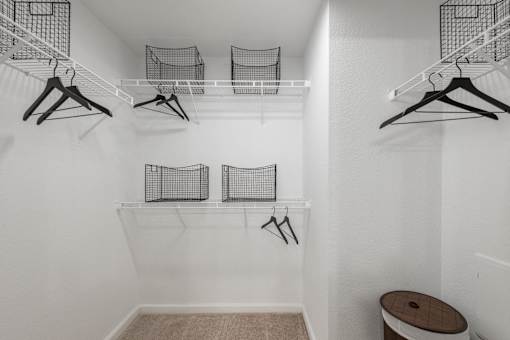 Walk-in closet with wire shelving, hanging space, and organized storage baskets.