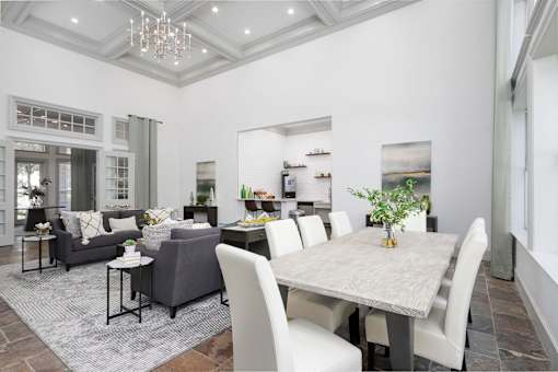 A dining room with a table and chairs.