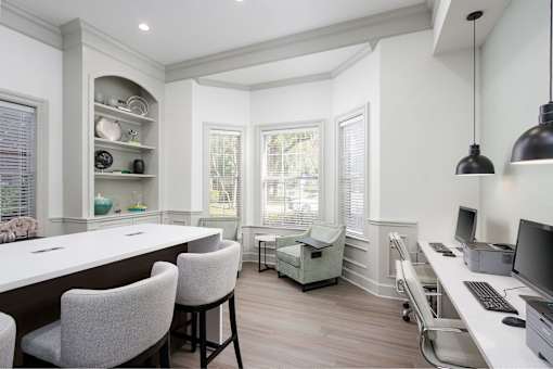 A well-lit, modern kitchen with a dining area and a home office.
