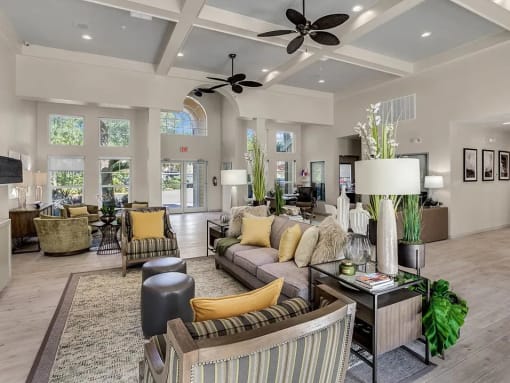 a living room filled with furniture and a large window