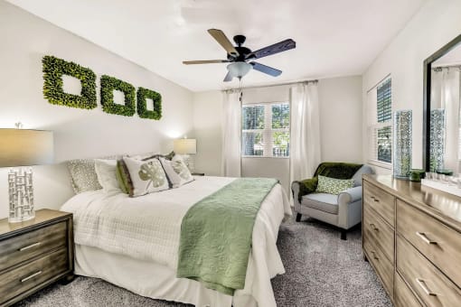a bedroom with a large bed and a ceiling fan