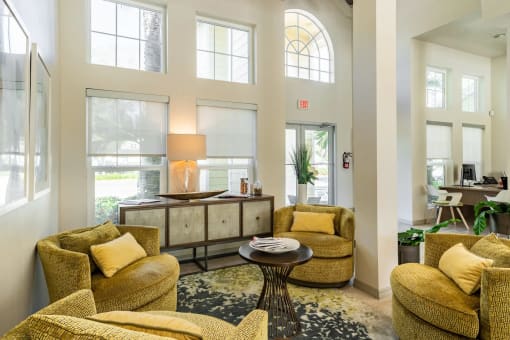a living room filled with furniture and a large window