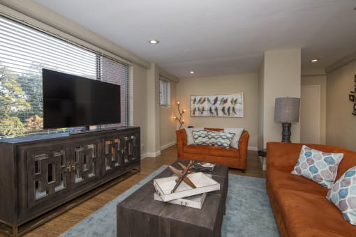 a living room filled with furniture and a flat screen tv