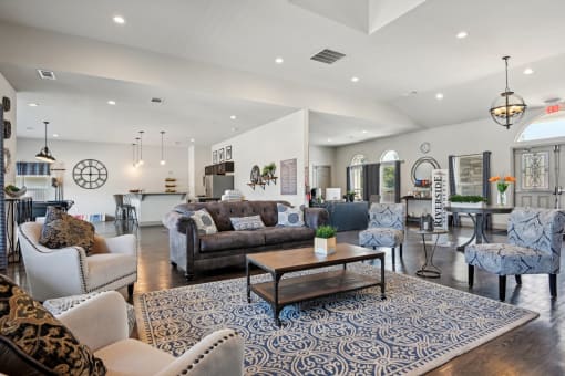 a living room with couches and chairs and a table