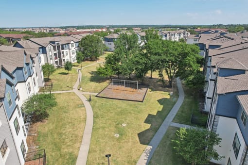 an aerial view of a neighborhood with houses and a park