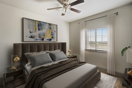 a bedroom with a large bed and a ceiling fan