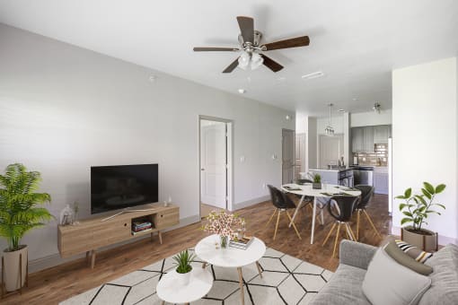 a living room with a ceiling fan and a dining room in the background