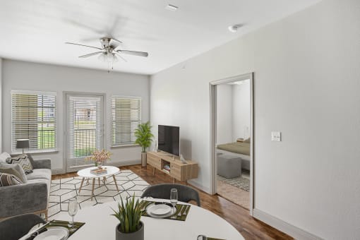 a living room with white walls and hardwood floors