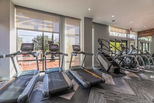 A gym with treadmills and other exercise equipment.