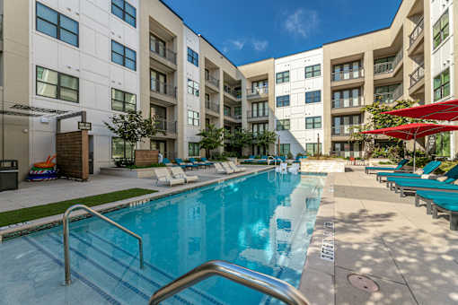 A swimming pool in front of apartment buildings.