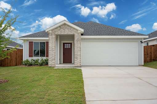 A house with a brown door and a grey garage door.
