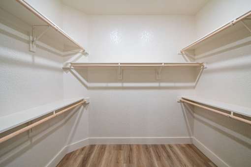 Empty white refrigerator with wooden floor.