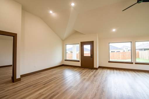 A room with wooden floors and a ceiling fan.