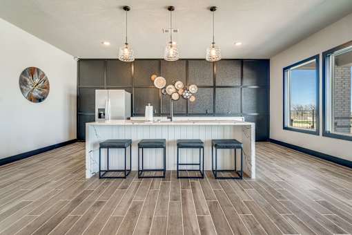A kitchen with a bar and stools.