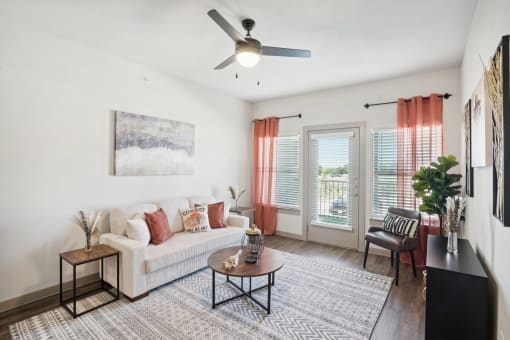 a living room with a couch and a ceiling fan
