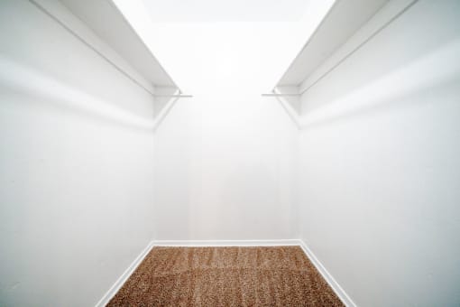 a empty room with white walls and a carpet