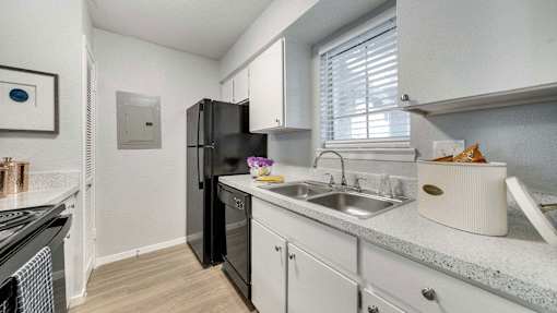 a kitchen with a sink and a refrigerator