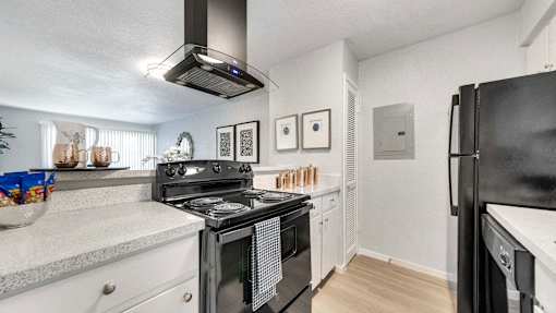 a kitchen with a stove and a refrigerator