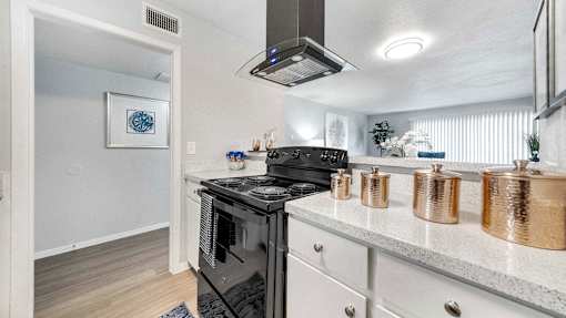 the kitchen has stainless steel appliances and a counter top with pots and pans