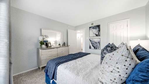 a bedroom with a bed and a dresser