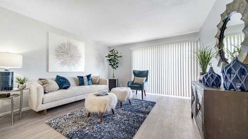 a living room with a couch and a chair and a rug