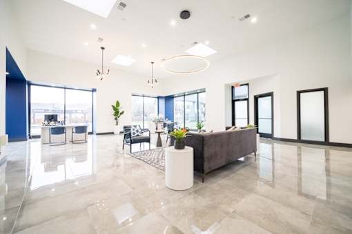 a large living room with a couch and a table with chairs