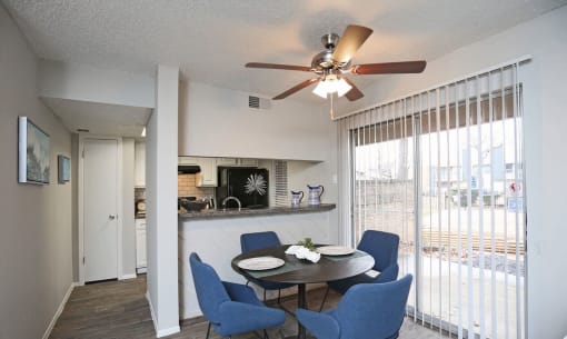 a dining room with a table and chairs and a ceiling fan  at 1505 Exchange Apartments, Fort Worth