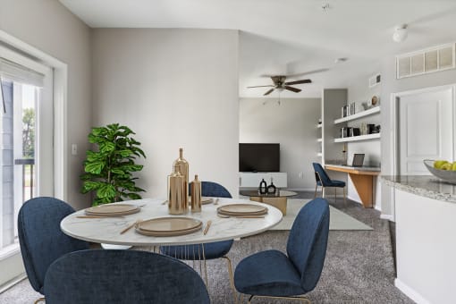 an open living room with a dining room table and chairs