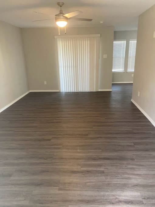an empty living room with a hard wood floor  at 1505 Exchange Apartments, Fort Worth