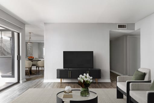 a living room with a flatscreen tv and a table