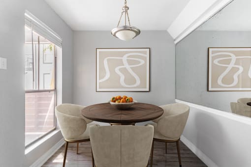a dining room with a table and chairs and a window