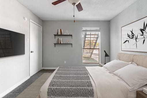 a bedroom with a large bed and a ceiling fan