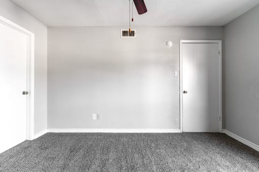 an empty room with carpet and a white door
