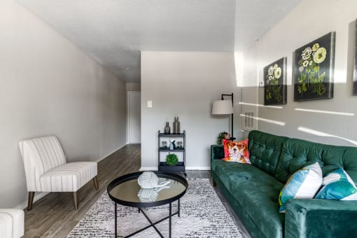 a living room with a green couch and a coffee table
