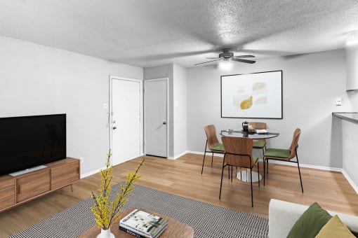 an open living room and dining room with a table and chairs