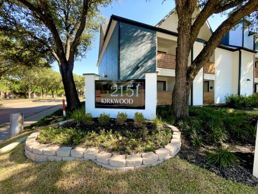 a sign with the address of a home with trees in the background  at 2151 Kirkwood, Houston, TX, 77077