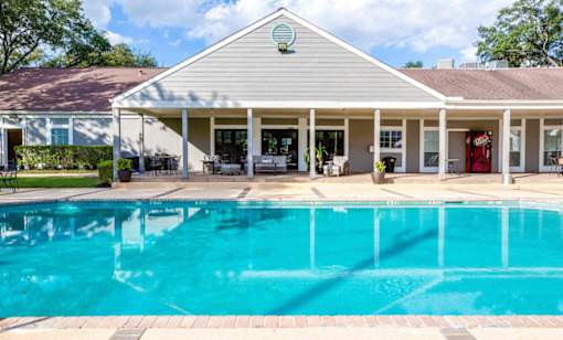 A house with a pool in front.